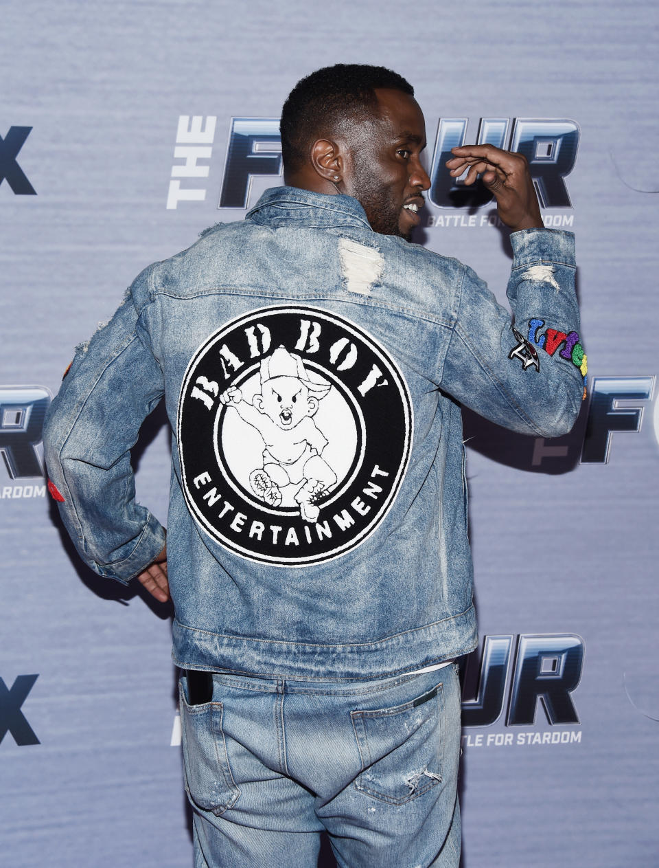 Combs shows off a denim jacket with the Bad Boy Entertainment logo on the back.