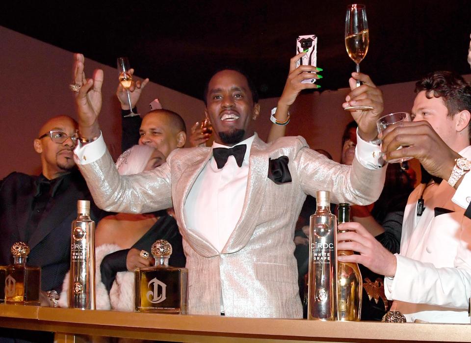 Sean Combs raises a glass to his 50th birthday.